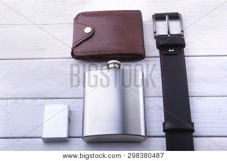 Gadgets And Accessories For Men On Light Wooden Background. Fashionable Men S Belt, Wallet, Lighter,