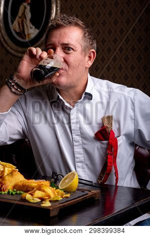Fabulous At Any Age. Portrait Of Fashionable 50-year-old Man In Stylish Siut Posing At Restaurant. T