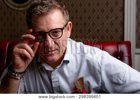 Fabulous At Any Age. Portrait Of Fashionable 50-year-old Man In Stylish Siut Posing At Restaurant. T