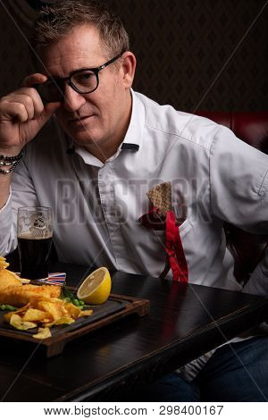 Fabulous At Any Age. Portrait Of Fashionable 50-year-old Man In Stylish Siut Posing At Restaurant. T