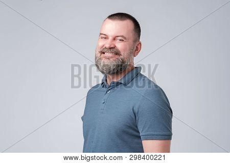 Confident Senior Man With Beard In Blue T-shirt Smiling