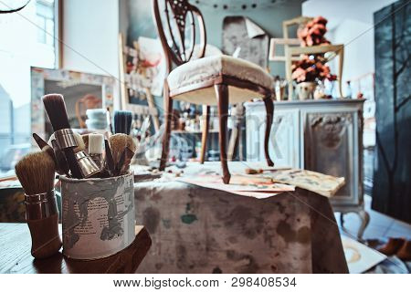 Artists Workshop With Necessary Eguipment Like Paint, Brushes, Frames, Flowers, Table, Chair And Cup