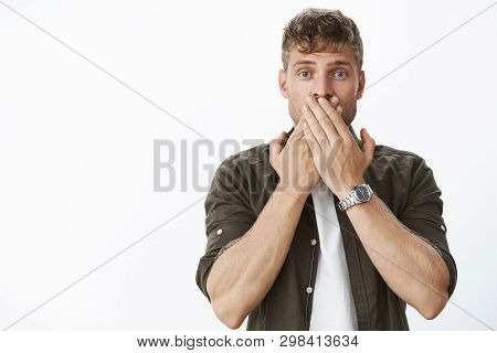 Waist-up Shot Of Shocked Speechless Handsome Blond Guy Hearing Unspeakable Astonishing News Covering