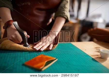 Warm Toned Close Up Of Female Artisan Making Leather Bag In Leatherworking Atelier, Copy Space