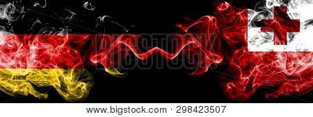 Germany Vs Tonga, Tongan Smoky Mystic Flags Placed Side By Side. Thick Colored Silky Smoke Flags Of 