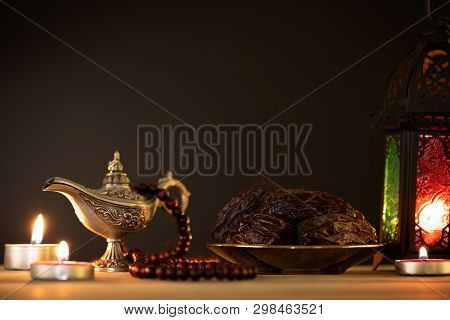 Ramadan Food And Drinks Concept. Ramadan Lantern With Arabian Lamp, Wood Rosary, Tea, Dates Fruit An