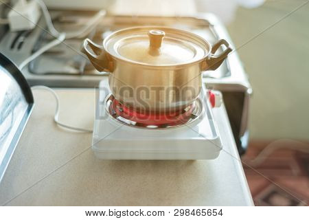 Small Electric Stove For Cooking. Portable Household Appliances. Food Prepared In The Home Kitchen W