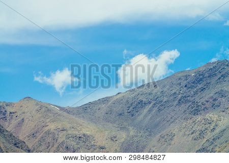 Amazing Giant Mountain Range With Snow Under Blue Sky With Clouds. Huge Mountain Ridge With Talus. S