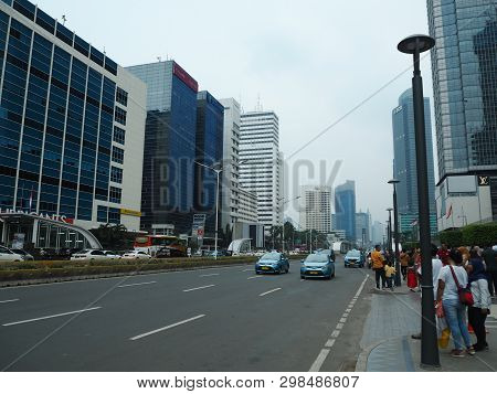 Jakarta, Indonesia - April 7, 2019: Crowd Of People Walking On The Pavement Of Jalan Thamrin (thamri