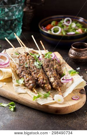 Lula Kebab From Minced Meat (beef, Lamb, Veal) On Pita Bread (lavash), Shish Kebab. With Red Onion,