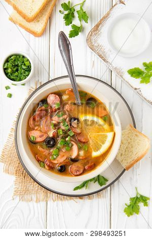 Traditional Russian Soup Solyanka With Beef, Chicken, Sausage, Lemon, Olives And Pickled Cucumber. D