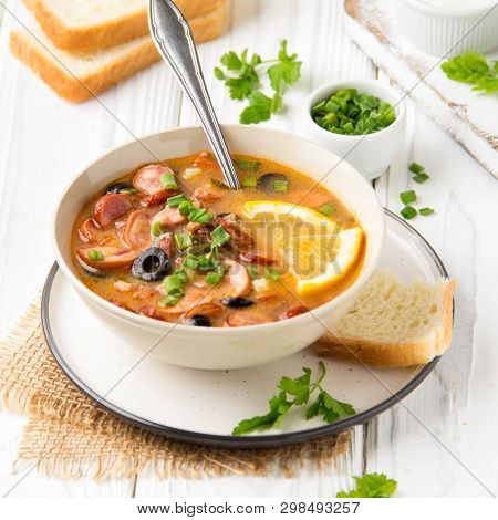 Traditional Russian Soup Solyanka With Beef, Chicken, Sausage, Lemon, Olives And Pickled Cucumber. D