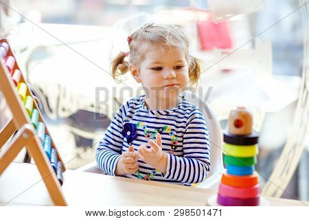 Adorable Cute Beautiful Little Toddler Girl Playing With Educational Wooden Rainbow Toy Pyramid And 