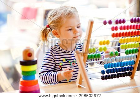 Adorable Cute Beautiful Little Toddler Girl Playing With Educational Wooden Rainbow Toy Pyramid And 