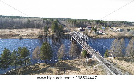 Aerial View On The Rail Bridge Across The River In Rural Place In Spring
