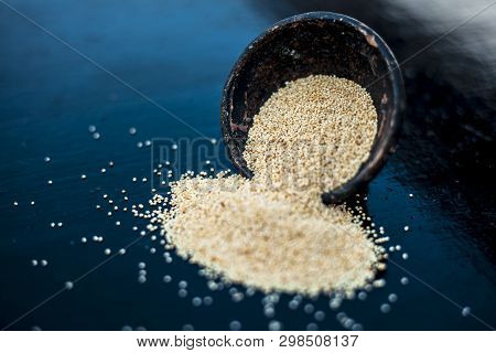 Close Up Of Clay Bowl On Wooden Surface Full Of Poppy Seeds Or Khus Or Opium Poppy Or Breadseed Popp