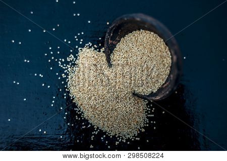Close Up Of Clay Bowl On Wooden Surface Full Of Poppy Seeds Or Khus Or Opium Poppy Or Breadseed Popp