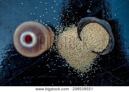 Close Up Of Clay Bowl On Wooden Surface Full Of Poppy Seeds Or Khus Or Opium Poppy Or Breadseed Popp