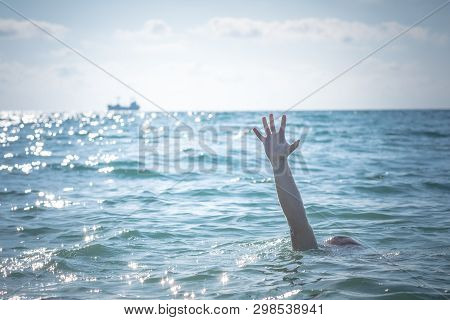 Single Hand Of Drowning Man In Sea Asking For Help