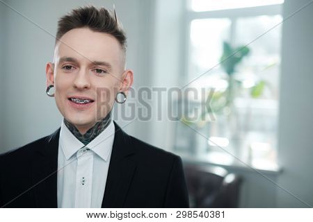 Portrait of alternative model with earplugs and tattoo
