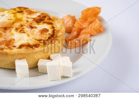 Tart Or Casserole With Salmon And Feta On White Plate
