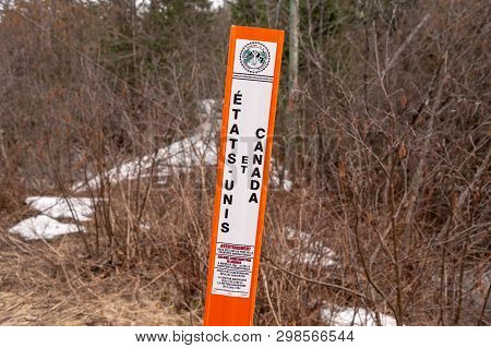 Saint-herménégilde, Qc, Canada - 21 April 2019: A Border Marker Marks The Us/canada Border.