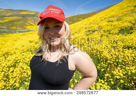 Taft, California - March 25, 2019: Blonde Republican Woman Wears A Donald Trump Make America Great A