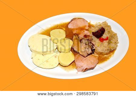 Pork Stewed With Cabbage And Knedliks. Orange Background