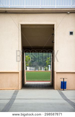 Entrance To The Football Stadium Through The Tunnel. Fence Around.