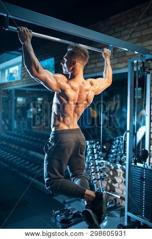 Young Bodybuilder With Perfect Body Pull Up With Gym Bar