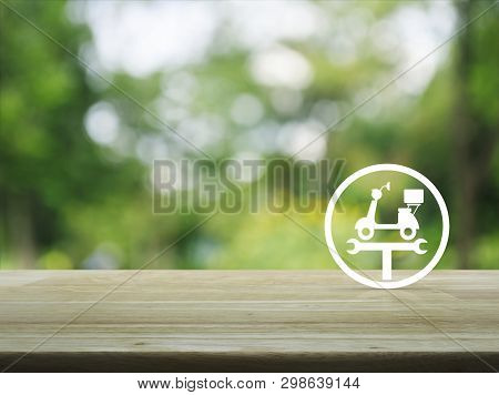Service Fix Motorcycle With Wrench Tool Flat Icon On Wooden Table Over Blur Green Tree In Park, Busi