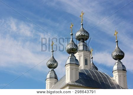 White Church With Five Domes With Golden Crosses And Blue Sky With Clouds. Empty Space For Your Text