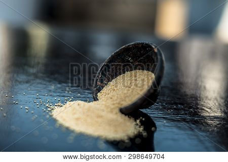 Close Up Of Clay Bowl On Wooden Surface Full Of Poppy Seeds Or Khus Or Opium Poppy Or Breadseed Popp