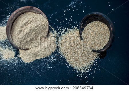 Close Up Of Clay Bowl On Wooden Surface Full Of Poppy Seeds Or Khus Or Opium Poppy Or Breadseed Popp