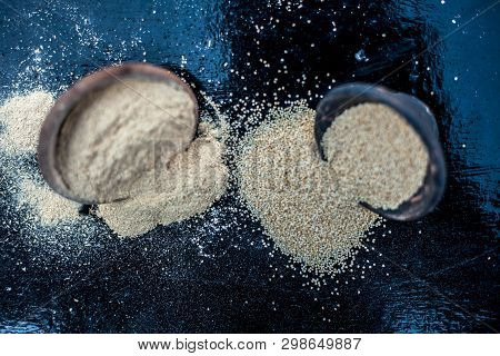 Close Up Of Clay Bowl On Wooden Surface Full Of Poppy Seeds Or Khus Or Opium Poppy Or Breadseed Popp