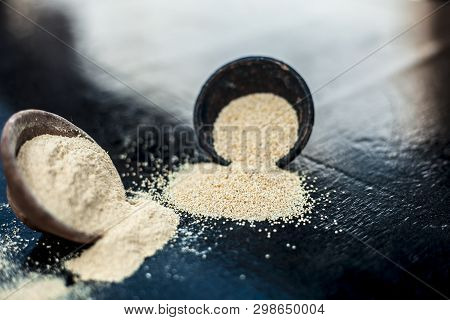 Close Up Of Clay Bowl On Wooden Surface Full Of Poppy Seeds Or Khus Or Opium Poppy Or Breadseed Popp