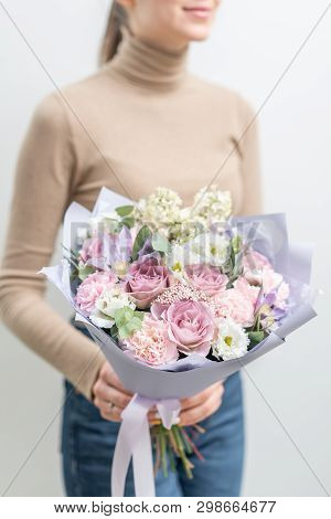 Beautiful Bouquet Of Mixed Flowers In Woman Hand. The Work Of The Florist At A Flower Shop. Delicate