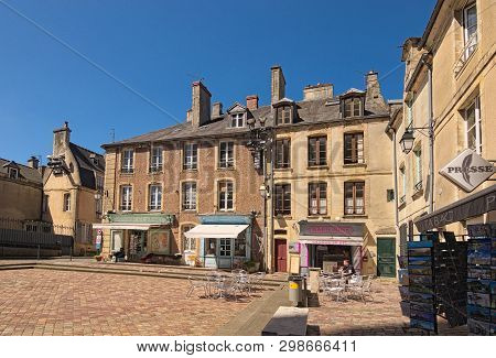 Bayeux, France-may 04,2018: The Small Square Lined With Shops And Cafes Outside The Entrance Of The 