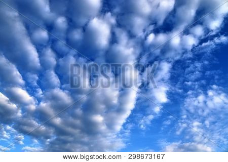 Beautiful Mixed Cloud Formations With White And Grey Cumulus Clouds In The Sunlight On A Blue Sky Se