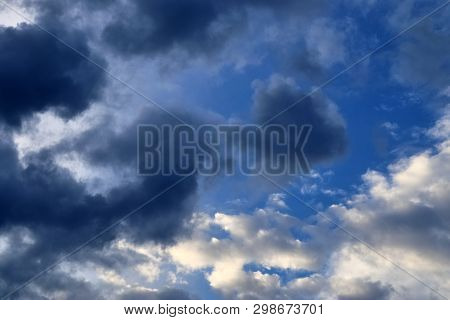 Beautiful Mixed Cloud Formations With White And Grey Cumulus Clouds In The Sunlight On A Blue Sky Se