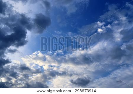 Beautiful Mixed Cloud Formations With White And Grey Cumulus Clouds In The Sunlight On A Blue Sky Se