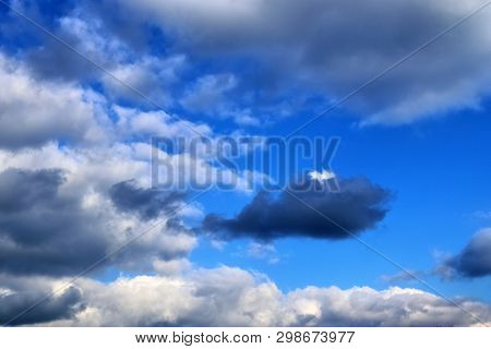 Beautiful Mixed Cloud Formations With White And Grey Cumulus Clouds In The Sunlight On A Blue Sky Se