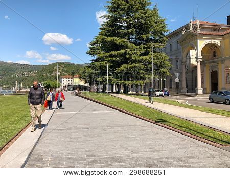 Luino, Lombardy, Italy - April 30, 2019: People Walking Along The Luino, Lakefront On The Coast Of L
