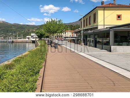 Luino, Lombardy, Italy - April 30, 2019: People Walking Along The Luino, Lakefront On The Coast Of L