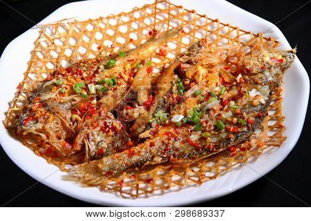 Fry Small Yellow Croaker In A White Ceramic Dish