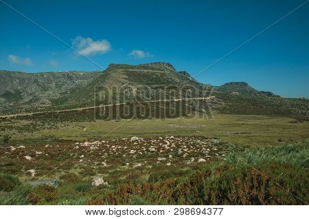 Concrete Retaining Wall Of Long And Tortuous Road Climbing Mountainous Landscape, At The Highlands O