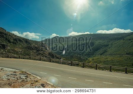 Concrete Parapet On Edge Of Road Passing Through Rocky Landscape In A Sunny Day, At The Highlands Of