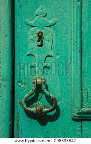 Close-up Of Wrought Iron Keyhole And Handle In An Old Wooden Worn Door On A Sunny Day At Unhais Da S