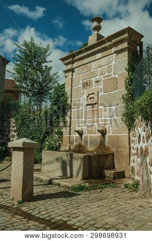 Charming Fountain Made Of Stone With A Small Water Spout, On A Deserted Alleys In A Sunny Day At Unh