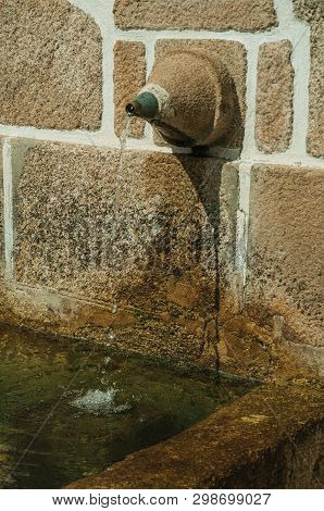 Charming Fountain Made Of Stone With A Small Water Spout, On A Deserted Alleys In A Sunny Day At Unh